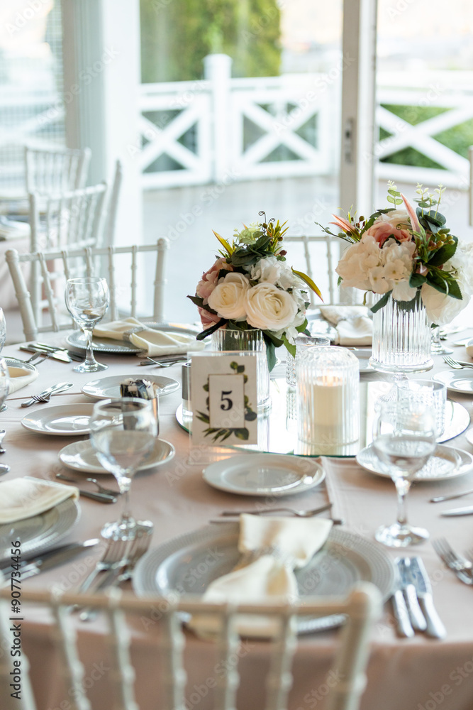 Elegant Wedding Table with Pastel Flowers and Greenery at Indoor Reception