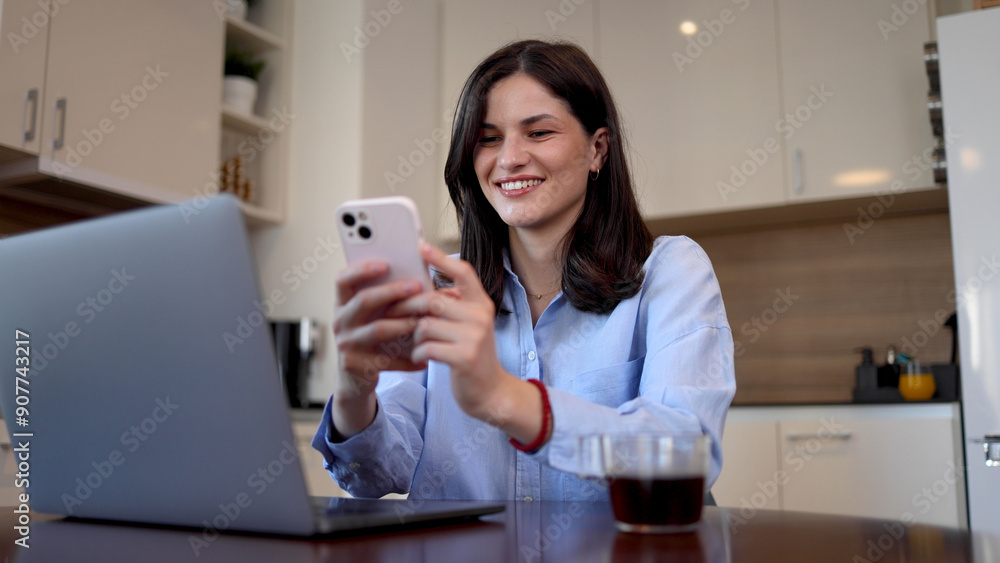 Beautiful woman working from her home office and using a smartphone Beautiful woman working from her home office and using a smartphone