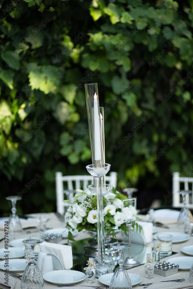 Refined Wedding Reception Table with White Centerpiece and Candlelight Outdoors