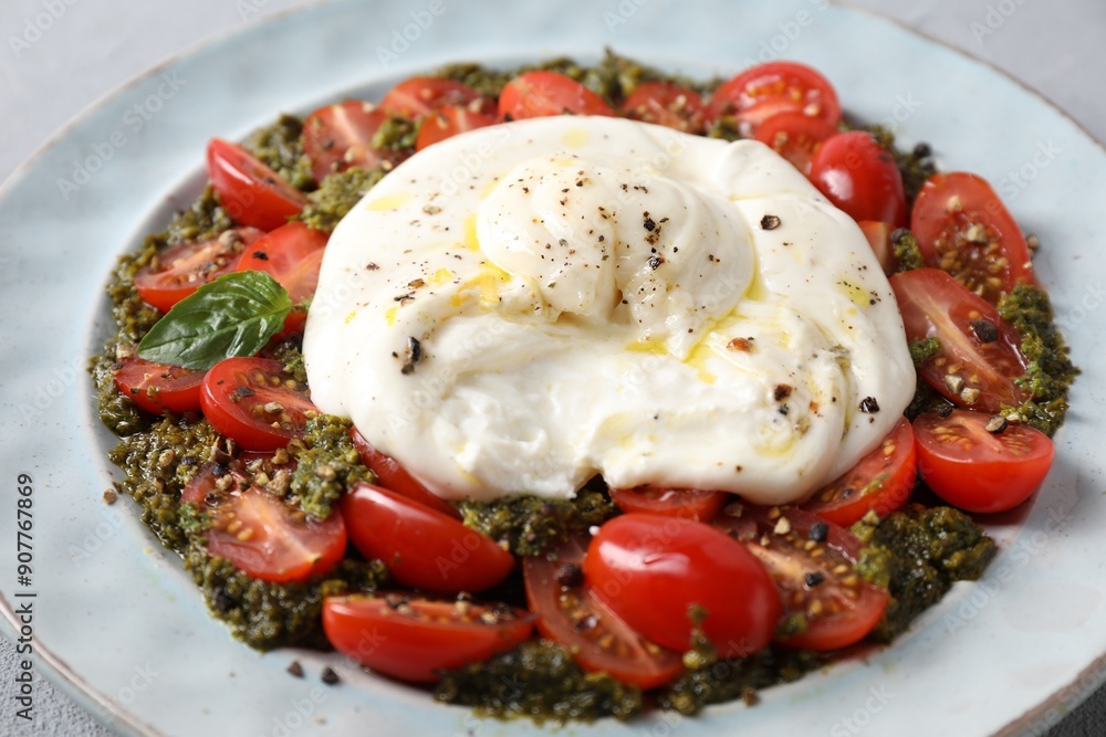 Fresh delicious burrata salad on table, closeup Fresh delicious burrata salad on table, closeup