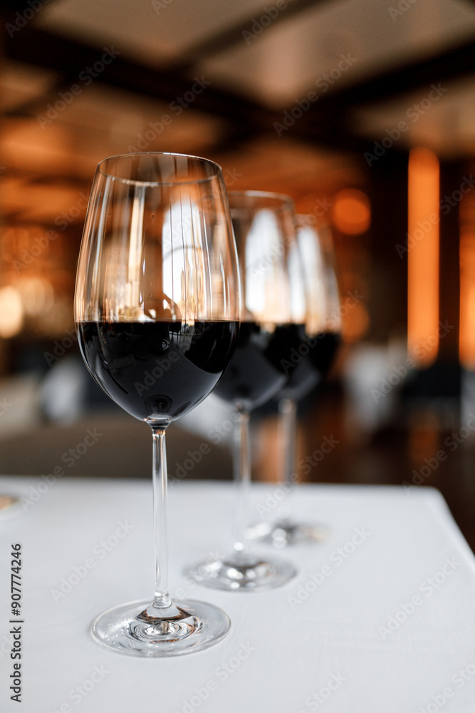 Red wine in a glass on a beautiful white tablecloth in a nice restaurant Red wine in a glass on a beautiful white tablecloth in a nice restaurant