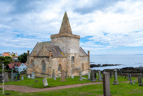 The ancient church of St Monans with its distinctive arched architecture and spier sitting proudly above the fishing village of the same name. photo