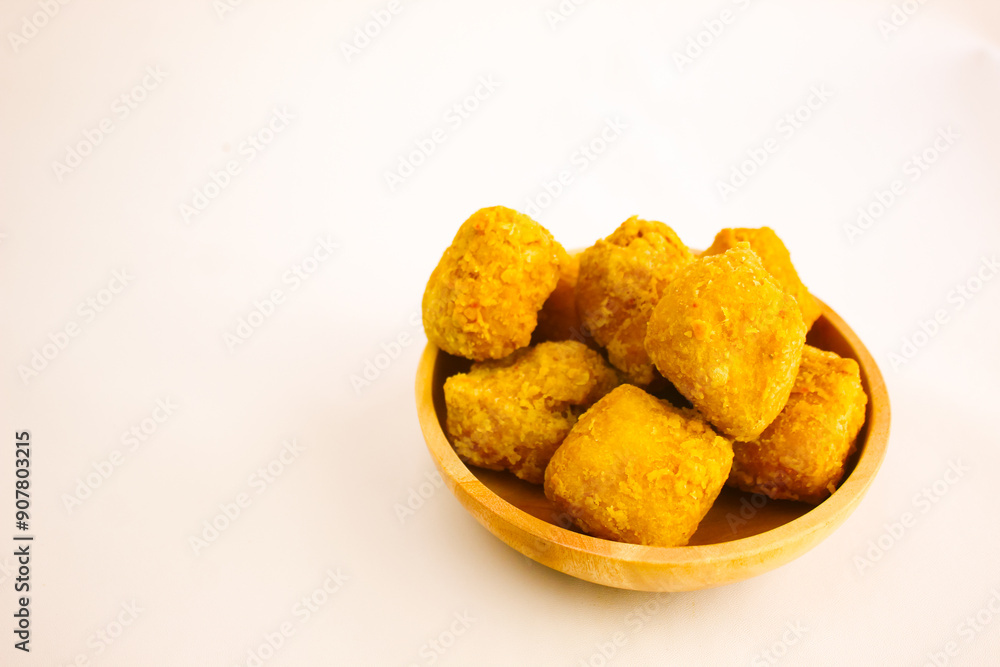 Tahu goreng cripsy, or crispy fried tofu, is one type of snack in Indonesia on wood plate isolated on white background. Perfect for recipe, article, catalogue, commercial, or any cooking contents
Tahu goreng cripsy, or crispy fried tofu, is one type of snack in Indonesia on wood plate isolated on white background. Perfect for recipe, article, catalogue, commercial, or any cooking contents