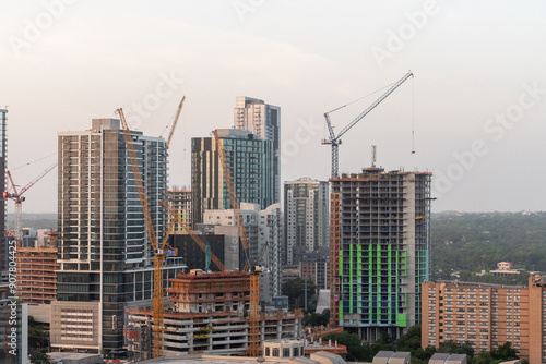 Austin, Texas, USA - July 27, 2023 - Tower Cranes and skyscrapers under construction on the downtown Austin Skyline at Sunrise 