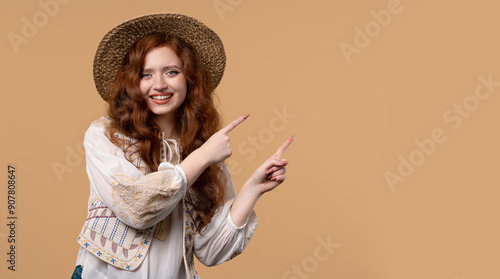 Recommending smiling woman pointing at right side, copy space or advertising. photo