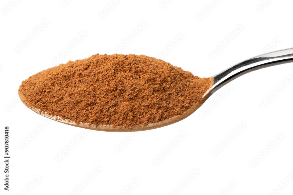 Metal spoon with ground cinnamon on white background close up Metal spoon with ground cinnamon on white background close up