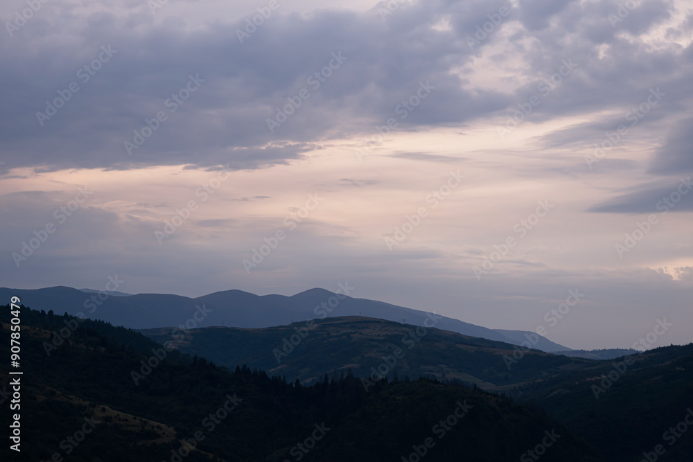 Gently pink sunset with the setting sun behind the mountains. Gently pink sunset with the setting sun behind the mountains.