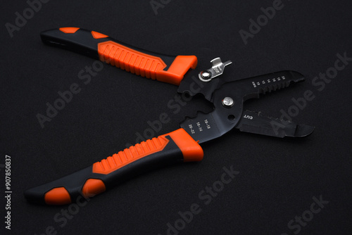 Insulation puller or stripper is an electrical installation tool on a black background.