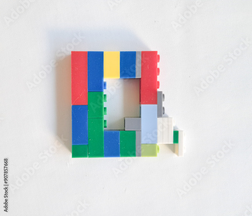 letter made from children toys on white background photo