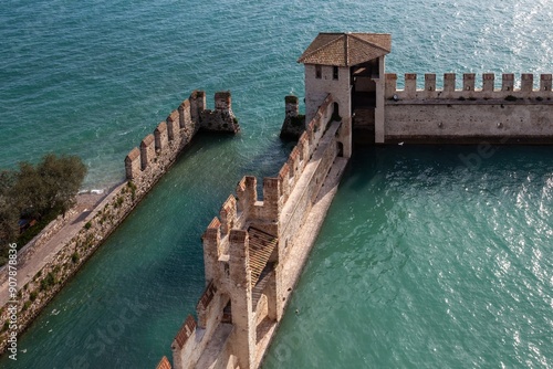 Rocca Scaligera lakeside castle in the medieval village of Sirmione del Garda against the backdrop of the lake photo