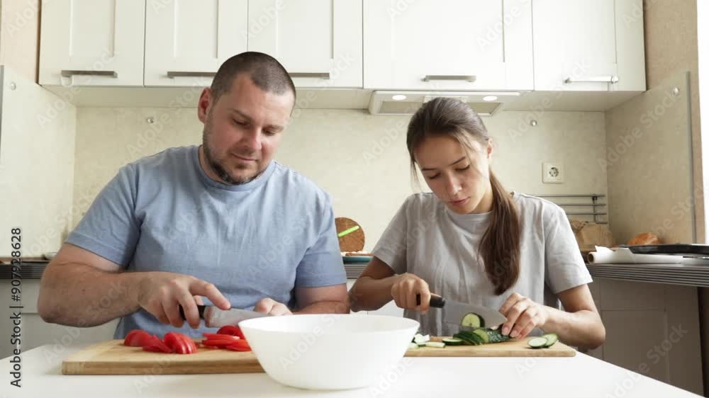 Teenage girl and father cooking salad at the kitchen, family joyfully preparing a meal, home filled with love and happiness. Teenage girl and father cooking salad at the kitchen, family joyfully preparing a meal, home filled with love and happiness.