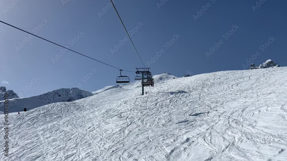 Ski lift between the forest in Courchevel ski resort Ski lift between the forest in Courchevel ski resort