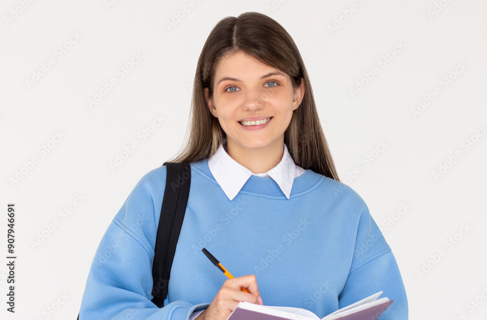 Happy teen student girl wear sweatshirt backpack hold book write down lesson in exercise book isolated on white background Education in university college concept