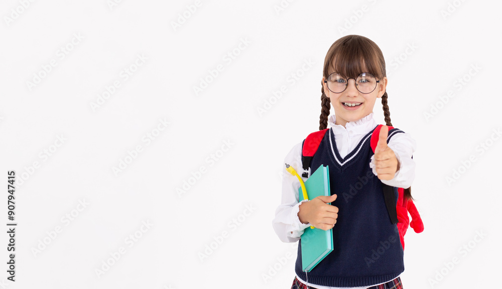 Cheerful School Girl Gesturing Thumbs-Up Smiling To Camera Posing Over white Studio Background. I Like School Concept. Panorama Cheerful School Girl Gesturing Thumbs-Up Smiling To Camera Posing Over white Studio Background. I Like School Concept. Panorama