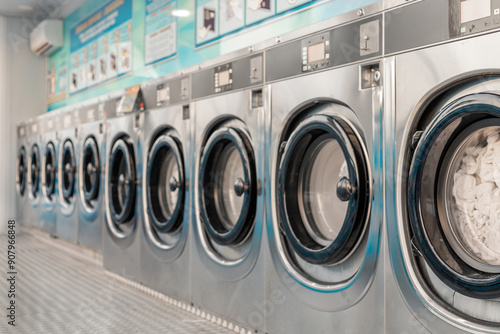 Fotografie Row of washing machines in public laundry