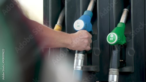 Refueling a Car at Gas Station with a fuel pump for oil or gasoline to fill up