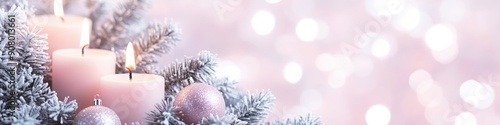 Pink candles on snowy branches, Advent and Christmas decorations with soft lights in background