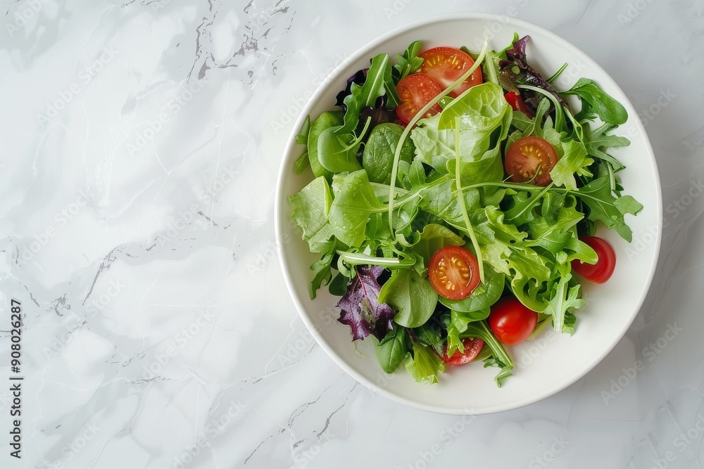 Fresh green salad with cherry tomatoes on a marble countertop. Place for text. Proper nutrition concept. Top view Fresh green salad with cherry tomatoes on a marble countertop. Place for text. Proper nutrition concept. Top view