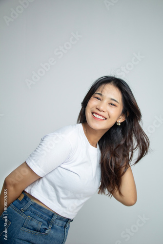 young asian woman shaking her long hair with loose smiling face, long hair ad in white suit, portrait isolated on white