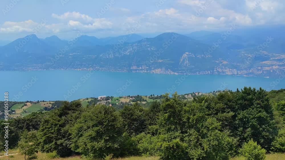 Stunning view of the blue colored Lake Garda and surrounding mountains from a cable car near the town of Prada, Italy. Stunning view of the blue colored Lake Garda and surrounding mountains from a cable car near the town of Prada, Italy.