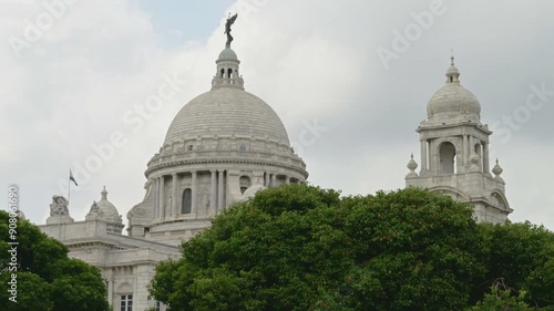 Victoria Memorial, large marble monument on the Maidan in Central Kolkata, West Bengal, India. Time lapse 4K video with monsoon sky and clouds passing over the architecture.