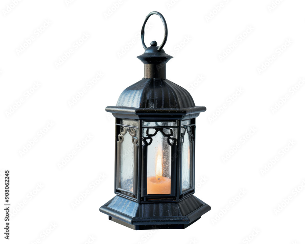 A black metal lantern with a lit candle inside, isolated on a black background. A black metal lantern with a lit candle inside, isolated on a black background.
