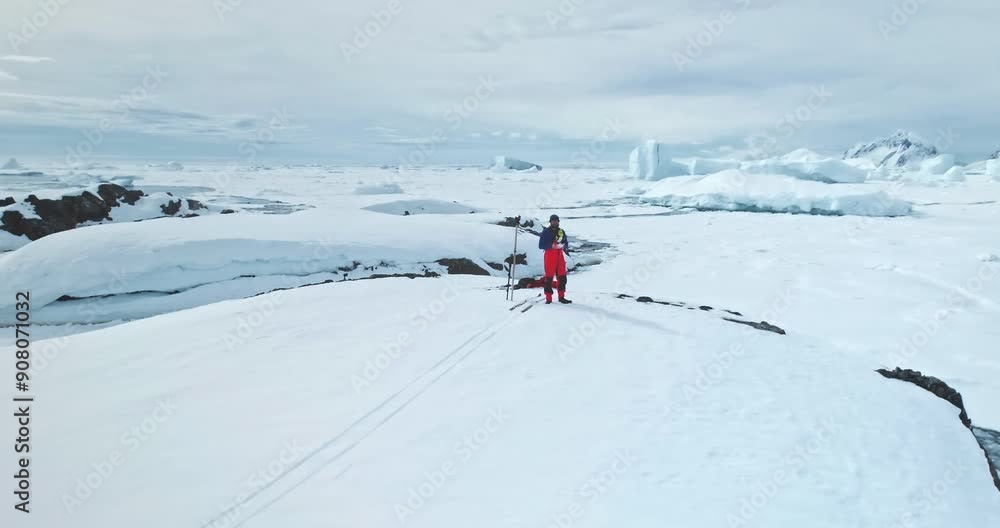 Man ski on snow-covered mountain hill in Antarctica. Tourist operate drone make panorama shot of winter glacier landscape. People travel, expedition, explore South Pole. Beauty wild untouched nature Man ski on snow-covered mountain hill in Antarctica. Tourist operate drone make panorama shot of winter glacier landscape. People travel, expedition, explore South Pole. Beauty wild untouched nature