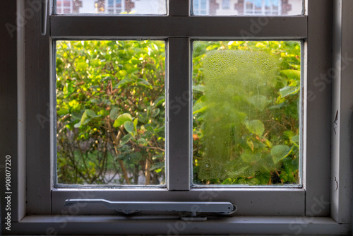 Bild auf Leinwand Wooden frame double glazed window showing condensation droplets between two pane