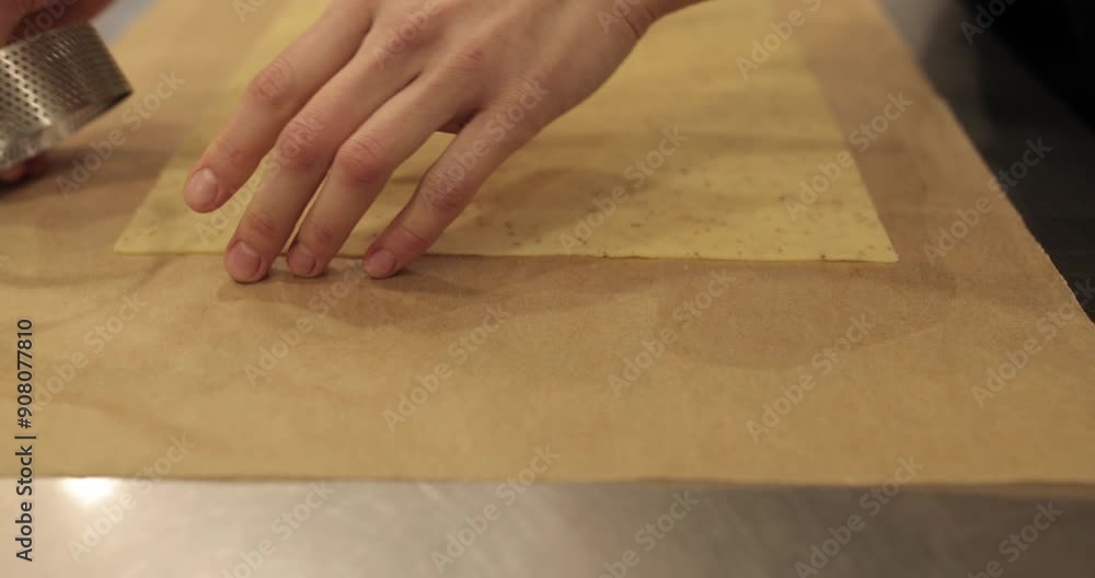 Preparation of dough for tarts. The chef measures and cuts the dough with his hands on the kitchen table. Female hands are preparing dough on a metal table Preparation of dough for tarts. The chef measures and cuts the dough with his hands on the kitchen table. Female hands are preparing dough on a metal table