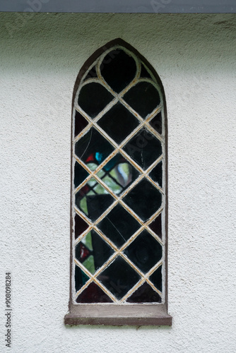 Small ornamental chapel window on the light wall
