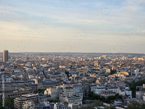 Wallpaper Mural Paris, France - April 12, 2024: Aerial view to the city of Paris, during the golden hour between modern skyscrapers and old buildings. Beautiful sunset over the city reflected on the buildings. Torontodigital.ca