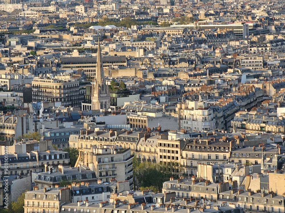 Paris, France - April 12, 2024: Aerial view to the city of Paris, during the golden hour between modern skyscrapers and old buildings. Beautiful sunset over the city reflected on the buildings. Paris, France - April 12, 2024: Aerial view to the city of Paris, during the golden hour between modern skyscrapers and old buildings. Beautiful sunset over the city reflected on the buildings.
