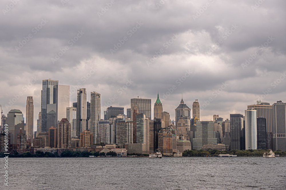 Fototapeta premium New York, NY, USA - August 4, 2023: Mid Manhattan skyline under gray menacing cloudscape, seen from the west