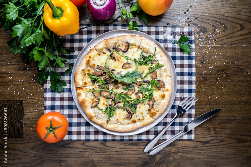 Mushroom Pizza with tomato, onion, capsicum, coriander, knife and fork served in dish isolated on napkin top view of italian fastfood on wooden table Mushroom Pizza with tomato, onion, capsicum, coriander, knife and fork served in dish isolated on napkin top view of italian fastfood on wooden table