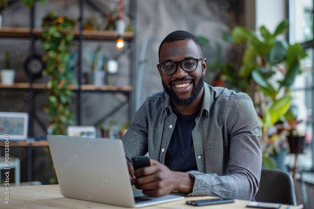 Successful young entrepreneur using a laptop and smartphone at a modern office, Generative AI Successful young entrepreneur using a laptop and smartphone at a modern office, Generative AI