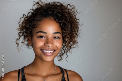 Happy young woman of color smiling at the camera in a studio, Generative AI