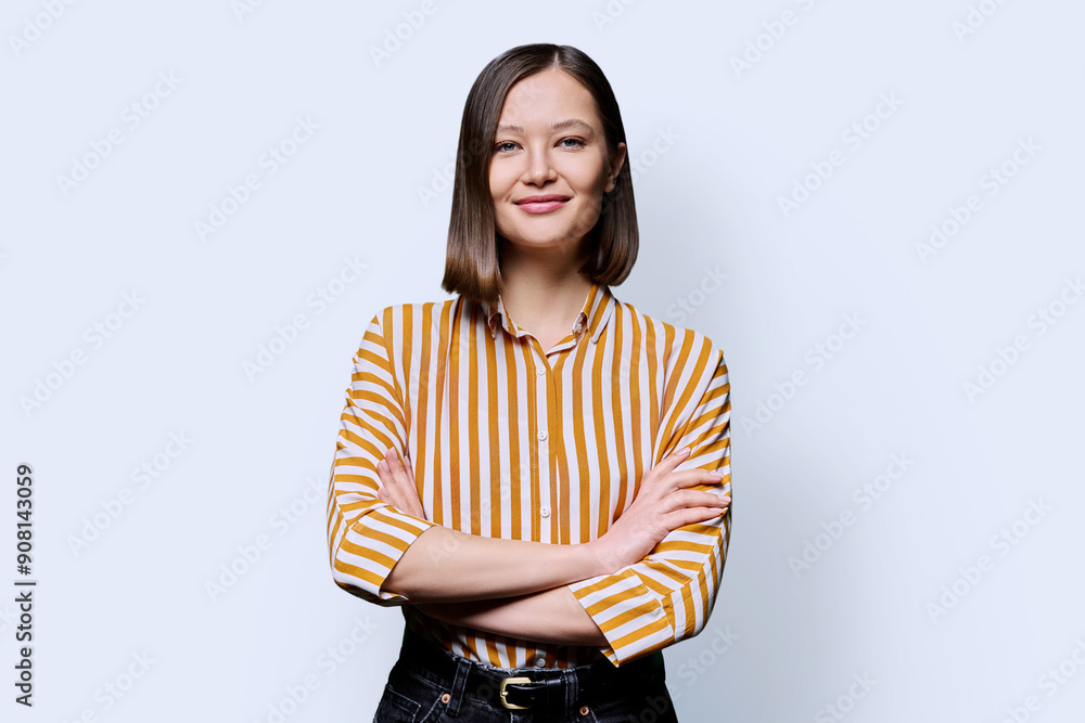 Young confident smiling woman with crossed arms on white background Young confident smiling woman with crossed arms on white background