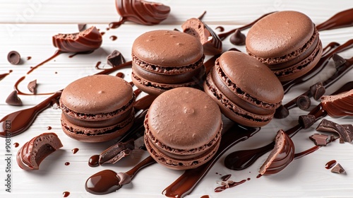  A neat stack of chocolate-covered macaroons atop a pristine white table, adorned with elegant chocolate drizzles