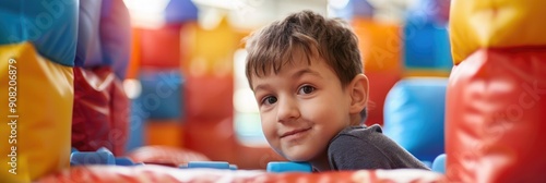 Active children s games in play center playroom playground Young boy playing amidst soft building blocks photo