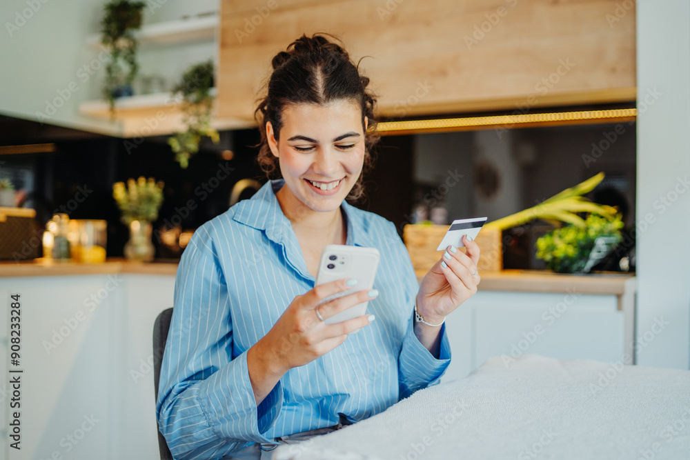 Young caucasian woman shopping online on mobile phone using credit card