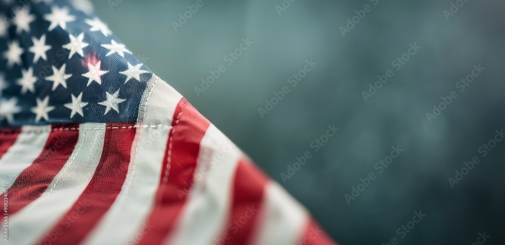 Obraz premium American Flag Waving Against Clear Blue Sky on a Sunny Day