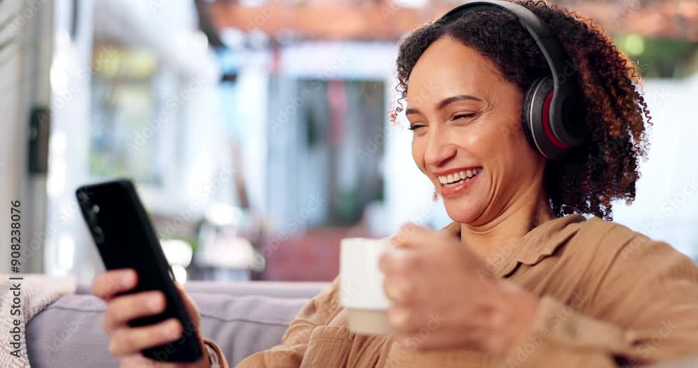 Woman, coffee or phone with headphones in home for relax, funny online video or scrolling social media on sofa. Mature person, break and subscription with laughing for podcast app or audio streaming Woman, coffee or phone with headphones in home for relax, funny online video or scrolling social media on sofa. Mature person, break and subscription with laughing for podcast app or audio streaming