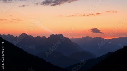 Wallpaper Mural The setting sun paints the clouds and shadows in vibrant hues of orange and pink casting a serene glow over the mountains. Torontodigital.ca