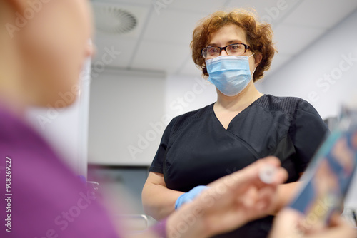 A nurse in the laboratory offers the patient a medical balloon for blowing to perform a test for Helicobacter photo