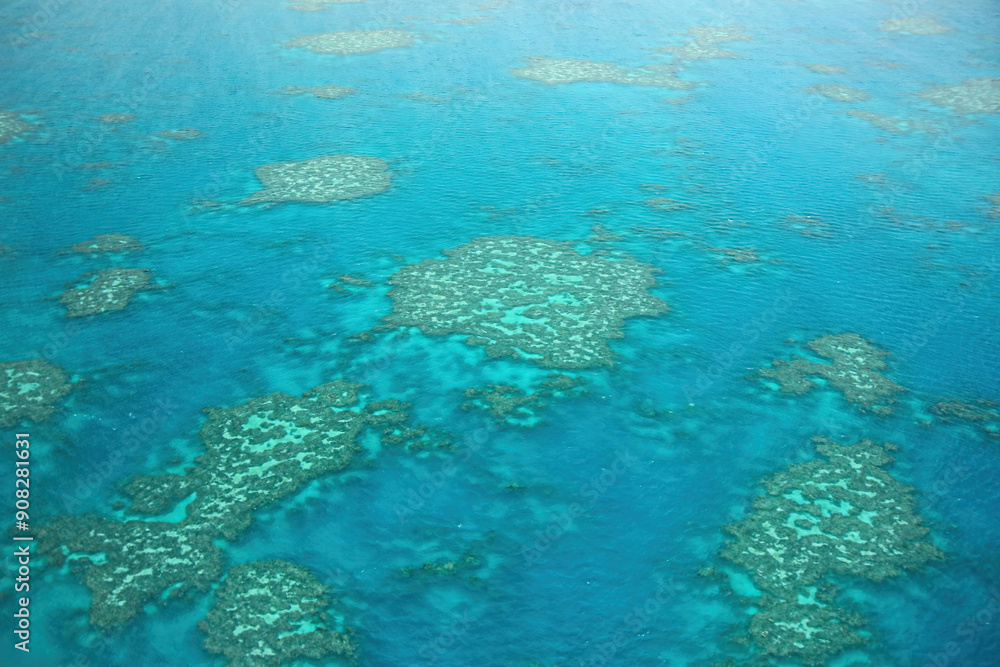 Aerial view of the Great Barrier Reef, the world's largest coral reef system located in the Coral Sea, off the coast of Queensland, Australia Aerial view of the Great Barrier Reef, the world's largest coral reef system located in the Coral Sea, off the coast of Queensland, Australia