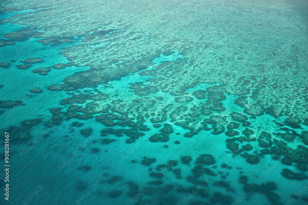 Aerial view of the Great Barrier Reef, the world's largest coral reef system located in the Coral Sea, off the coast of Queensland, Australia Aerial view of the Great Barrier Reef, the world's largest coral reef system located in the Coral Sea, off the coast of Queensland, Australia