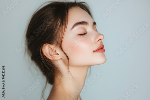 A close up of a girl's face with her eyes closed