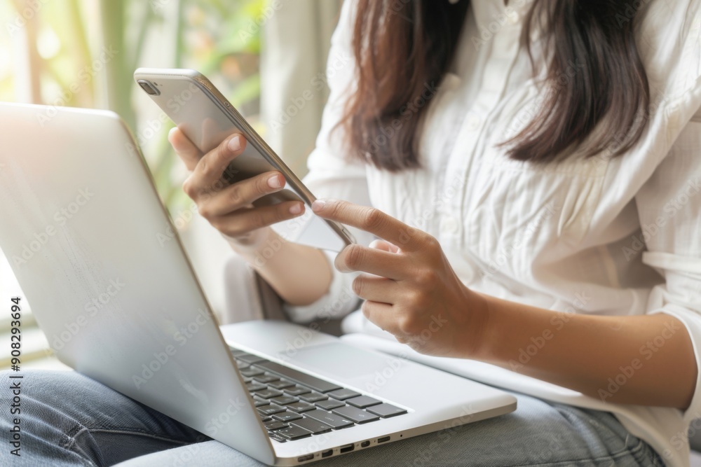 Close-up of businesswomen using smartphones and tablets in an office, highlighting digital tools and modern work practices. Close-up of businesswomen using smartphones and tablets in an office, highlighting digital tools and modern work practices.