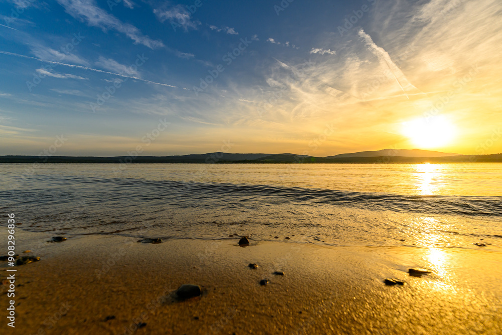 Romantic summer sunset on the beach by the lake Romantic summer sunset on the beach by the lake