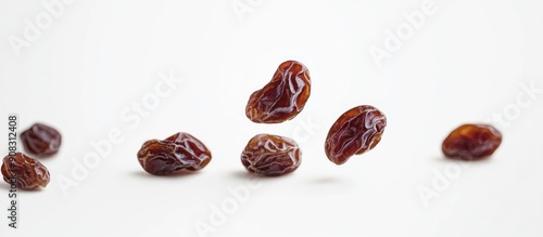 Raisins Falling on White Surface